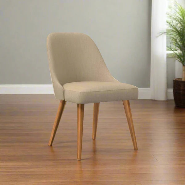 Beige chair with wooden legs on a wooden floor