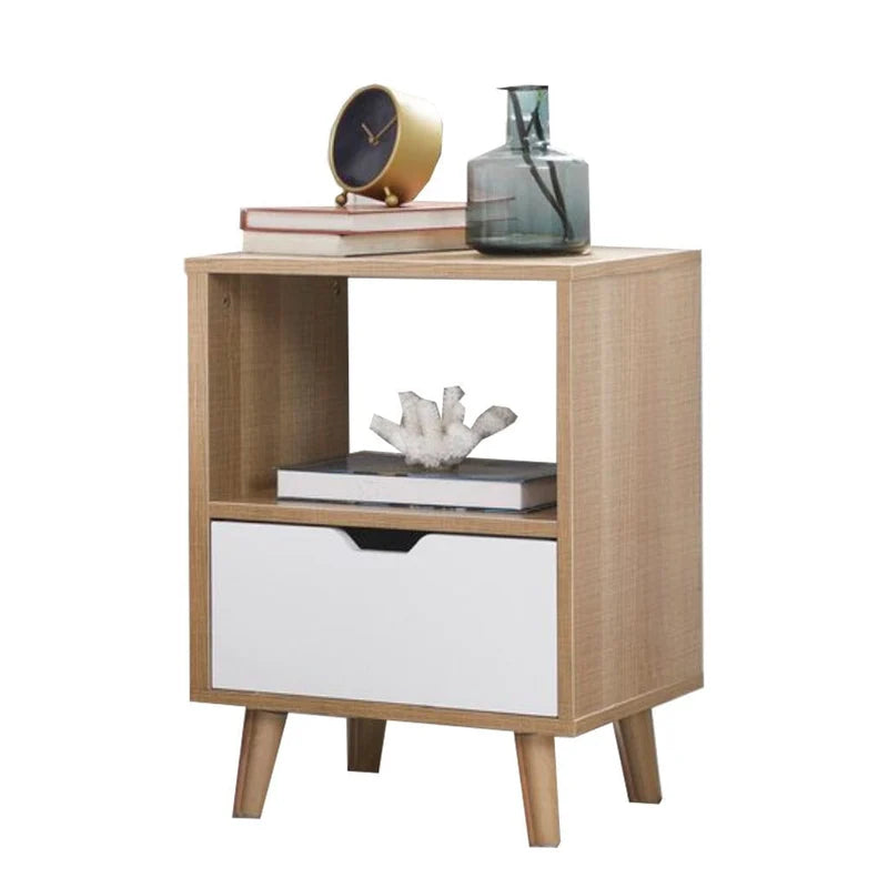 Wooden nightstand with a white drawer, books, and decorative items on top.