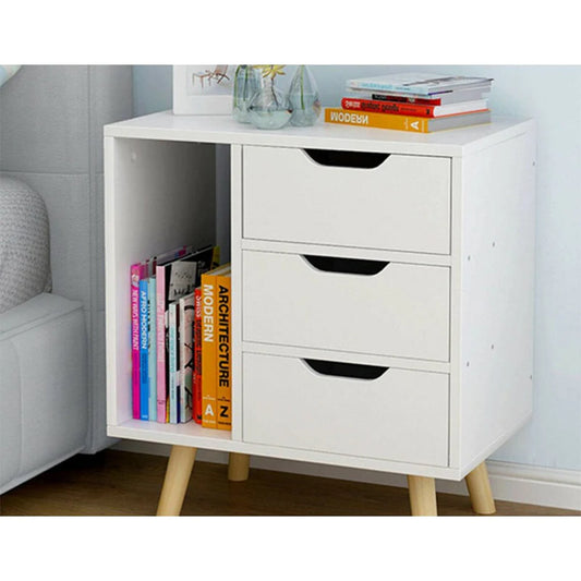 White storage cabinet with drawers and books in a room setting