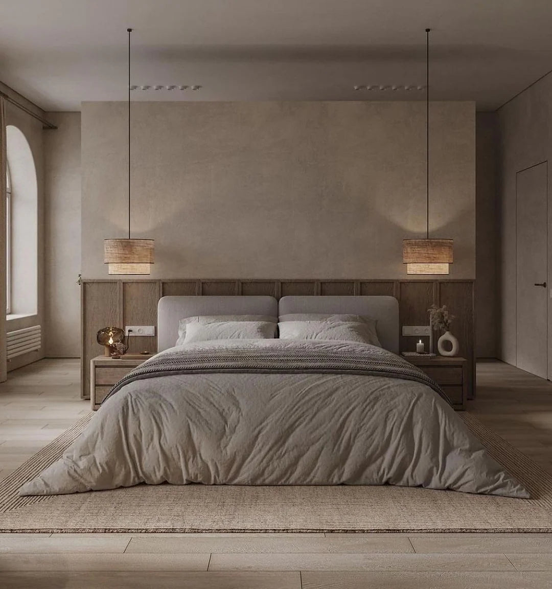 Modern bedroom with a large bed, wooden headboard, and minimal decor.