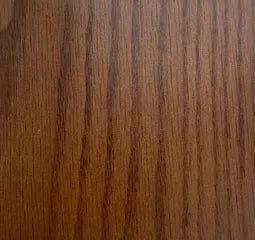 Close-up of a wooden surface with a rich brown color and visible grain pattern.