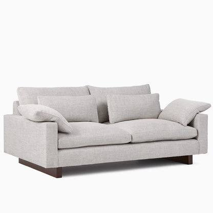 Gray sofa with cushions on a white background
