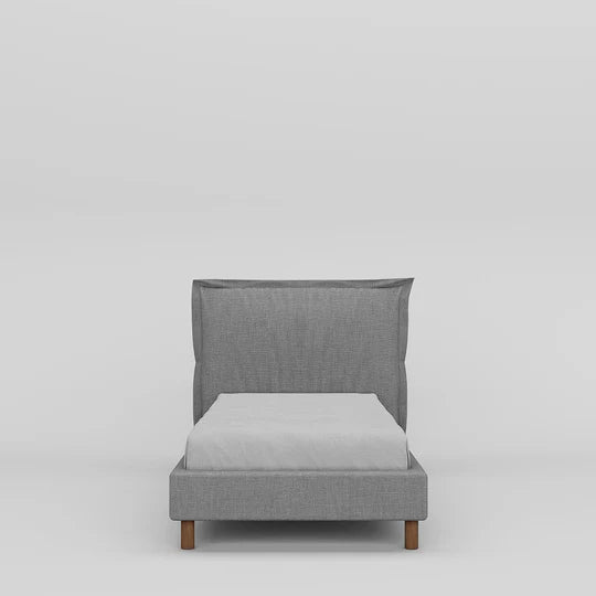 Gray upholstered bed with a white mattress on a light gray background