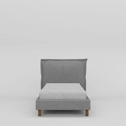 Gray upholstered bed with a white mattress on a light gray background