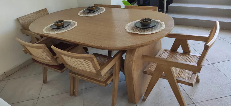 Wooden dining table with chairs on a tiled floor