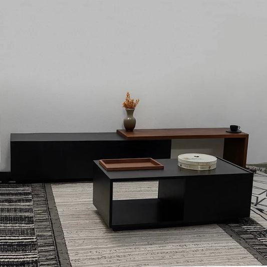 Modern living room with a black coffee table and wooden sideboard against a gray wall.