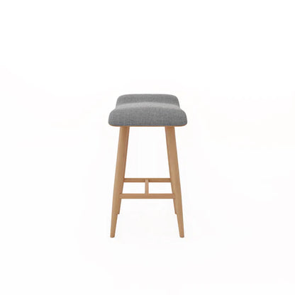 Bar stool with gray cushioned seat and wooden legs on a white background