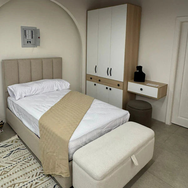 Modern bedroom with bed, wardrobe, and bench.