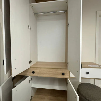 Open wardrobe with a wooden shelf and drawers in a room setting.