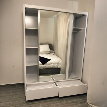 White wardrobe with mirror and drawers in a bedroom setting