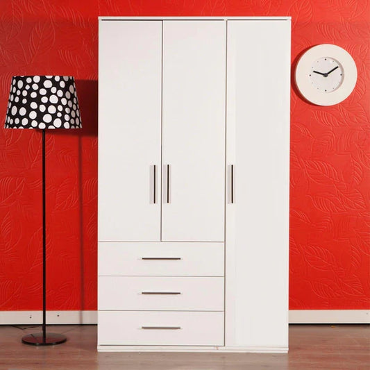 White wardrobe with black and white polka dot lamp against a red wall.