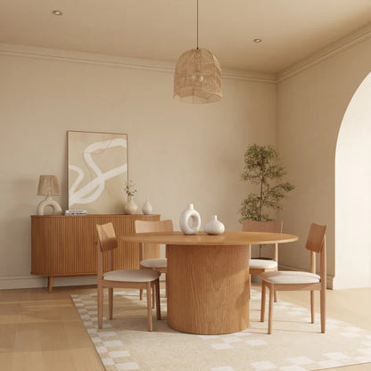 Dining room with wooden table and chairs, neutral color scheme.