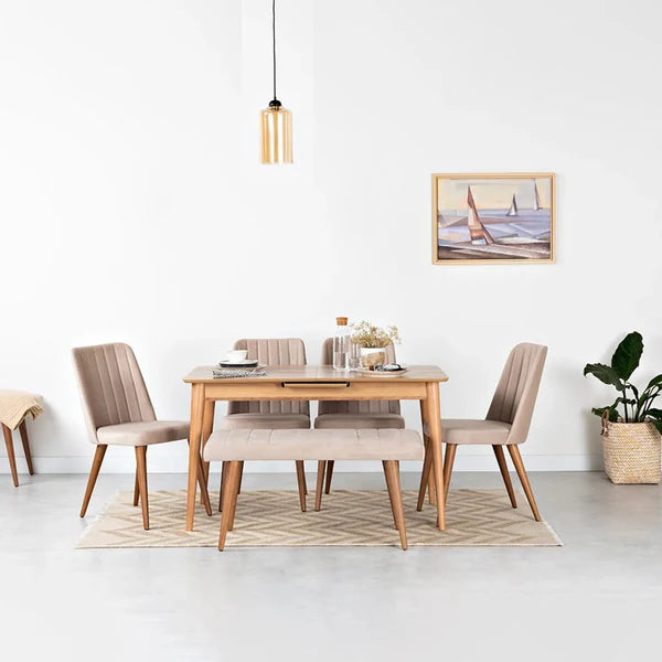 Dining room with wooden table and chairs, pendant light, and framed picture on a white wall.