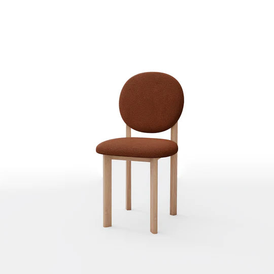 Brown upholstered chair with wooden legs on a white background
