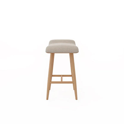 Bar stool with beige cushioned seat and wooden legs on a white background